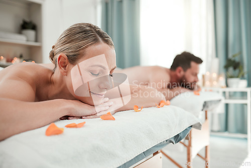 Image of Spa, massage and couple relax in luxury treatment for health, wellness and therapy session at a resort. Man and woman enjoying a calm day of zen, care and relaxation lying on a table for vacation