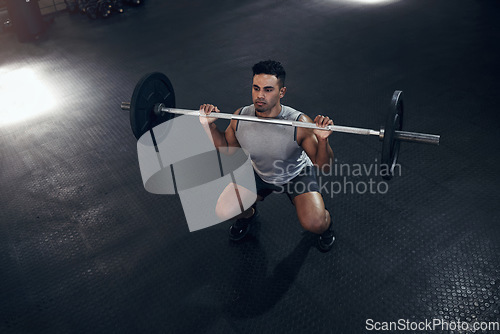 Image of Barbell exercise, gym man and sports training, workout and fitness of heavy weights press in health club. Above of indian bodybuilder, serious male athlete and body muscle, power or strong motivation