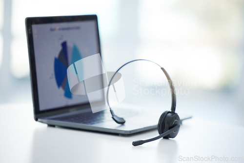 Image of Empty call center, laptop and sales headset for telemarketing, crm data research and tech innovation in receptionist office. Background zoom, online customer service support and analytics consulting