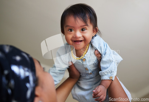 Image of Happy, down syndrome baby and child mom care of a woman holding a kid with a disability at a house. Happiness and smile of a young toddler special needs face from India in a home with a mother