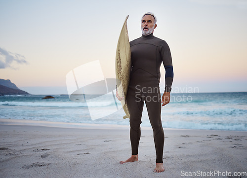 Image of Surfing, beach and senior man on vacation for surf training in nature by ocean in Australia. Travel, surfboard and elderly surfer in retirement on summer holiday to exercise, relax and enjoy the sea.