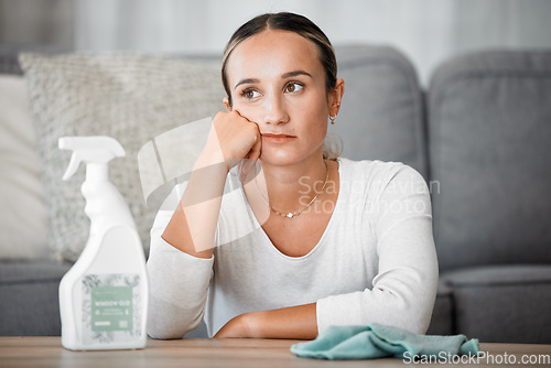 Image of Cleaning, tired and bored with a woman cleaner thinking while in her home to clean, tidy and disinfect. Unhappy, sad and apartment with a female in her living room for hygiene, washing or sanitizing