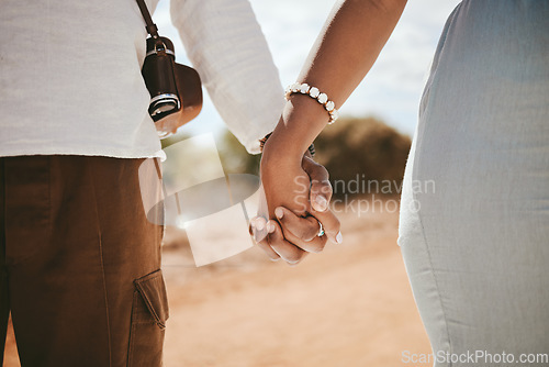 Image of Hand holding, couple and black people travel together on a road trip ready for a safari holiday. Support, trust and vacation love of people hands united in nature in the summer sunshine