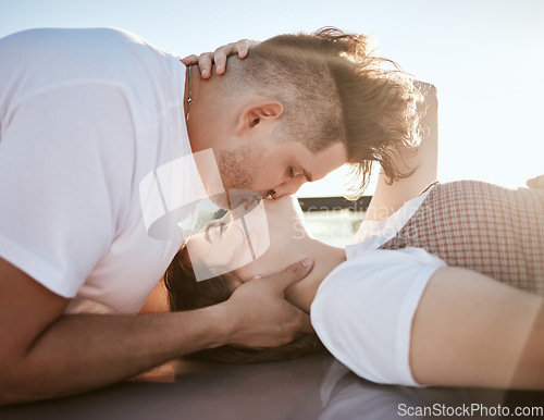 Image of Love, intimacy and couple kiss and relax together outdoor, touching lips and having fun. Romance, flirting and affection by young man and woman showing desire and passion while kissing outside