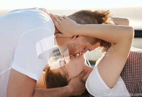 Image of Couple, love and kiss with a man and woman on a road trip for their honeymoon, vacation or travel. Romance, kissing and together with a male and female enjoying a date together during summer