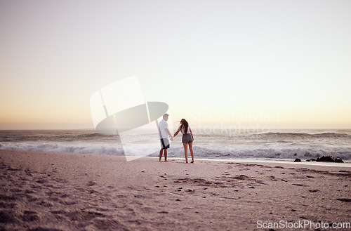 Image of Beach, sunset and couple holding hands on date in summer, outdoor holiday or vacation with sand and sky mockup. Love, care and travel with affection people walking by sea, horizon mock up background