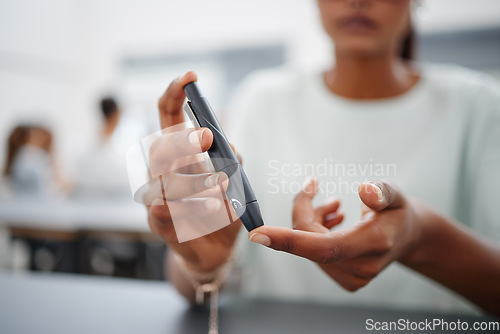 Image of Diabetes, finger and black woman with blood sugar test on to check levels of student while sitting at desk. Healthcare, health and female prick to use glucose meter for insulin and wellness