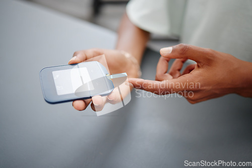 Image of Diabetes, digital and blood sugar test with hands of black woman check with glucometer for healthcare, analysis and insulin levels. Results, wellness and medical device with finger of patient