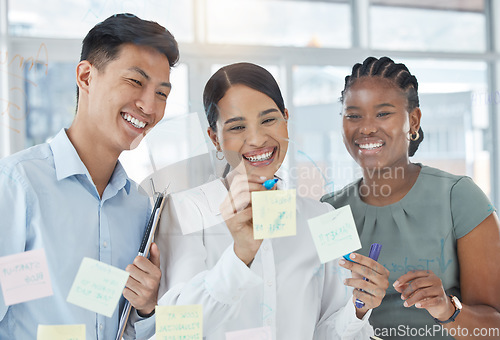 Image of Teamwork, planning and sticky note meeting with business people writing on window for scrum marketing strategy, collaboration or goals. Vision, innovation and management with employee working on idea