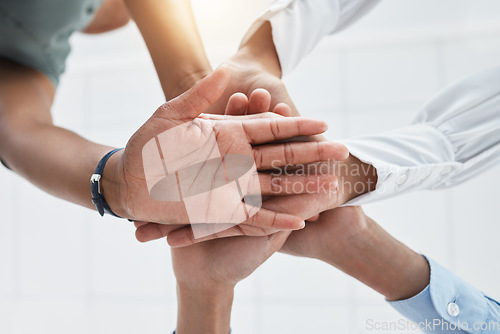 Image of Collaboration, team building and hands in support of company success with business people in unity low angle. Trust, goal and about us worker team share motivation, vision and idea while having fun