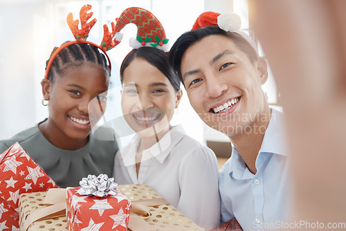 Image of Christmas, selfie and business people with gift for giving, love and celebration with holiday office party or workplace culture and diversity. Corporate staff in portrait pov picture with present box