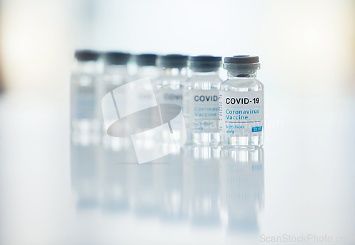 Image of Healthcare, medicine and covid vaccine bottle, stock and product in a hospital office. Healthcare with a virus cure, wellness or corona drug in a medical research clinic for safety from covid 19