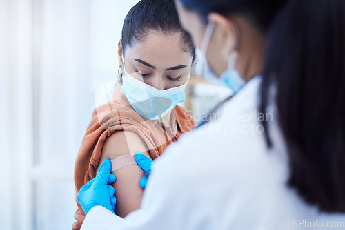 Image of Covid vaccine, doctor and patient with face mask for safety, compliance and healthcare at a hospital or clinic. Woman with medical worker expert in office consultation for corona virus medicine help