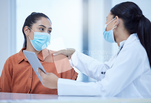 Image of Covid, face mask and doctor on tablet consulting patient for corona virus vaccine or treatment. Health, safety and medical woman talking, help or support for covid 19 checkup in hospital on tech.