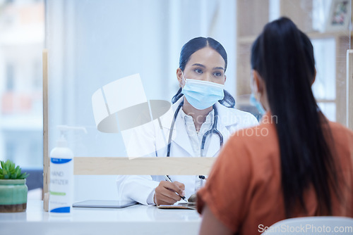 Image of Covid, consulting and doctor and woman at desk and glass window for help, medical and therapy in clinic. Safety, medicine and checklist with patient and healthcare professional in counseling room