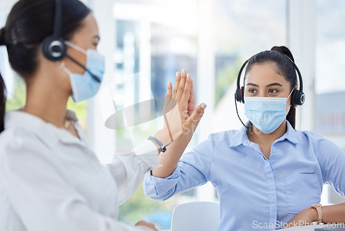 Image of Covid, high five and women in call center with face mask for office compliance, target success or goal achievement. Sales, telemarketing or e commerce business people hands teamwork, support and care