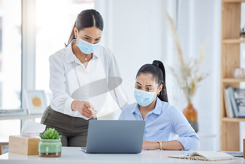 Image of Covid, training and employees talking with laptop in an office together at work. Corporate workers speaking about strategy for business, reading email and working on a proposal on a pc with face mask