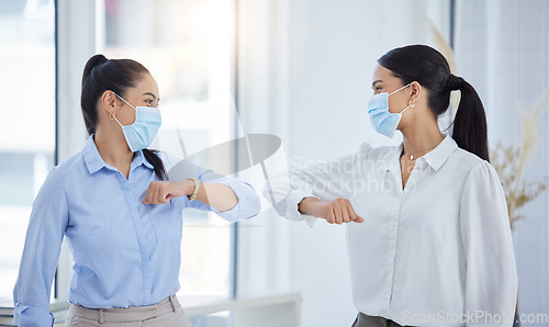 Image of Business team, elbow bump and covid safety with employees greeting doing social distance in an office. Manager and woman in office during coronavirus with a face mask and working after lockdown