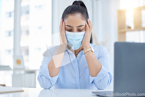 Image of Stress, covid and headache of a business woman in her office working at desk with laptop for compliance, health problem or tech job. Burnout, anxiety and mental health corporate worker in a face mask