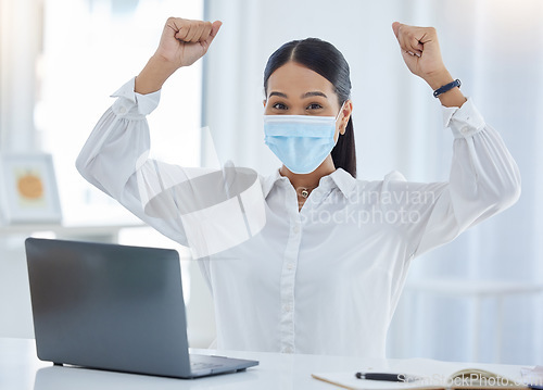 Image of Business woman in office, covid mask and celebrate success at work during pandemic. Young corporate person in portrait, working with laptop and winner, presentation victory and job well done.