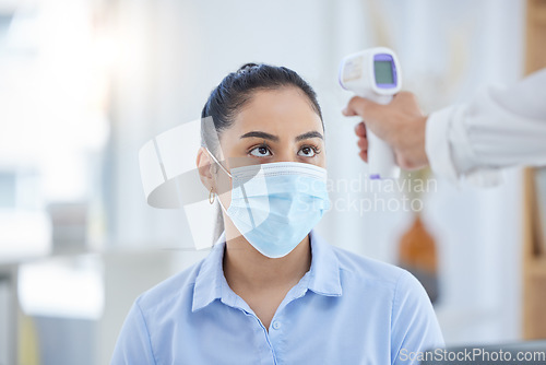 Image of Woman, covid 19 and thermometer for safety, health and sign of infection. Doctor, patient and technology in face with mask for wellness, protection and stop of coronavirus sickness in Los Angeles