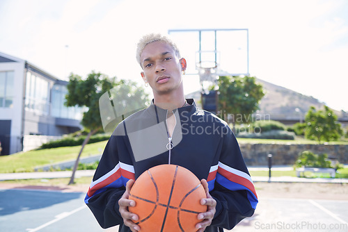 Image of Sports, basketball court and a portrait of man with ball outside at park. Exercise, motivation and workout for fitness, wellness and health. Street game, outdoor basketball training and serious face.