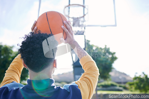 Image of Man, basketball and shooting hoops for training, practice and workout on basketball court. Basketball player, athlete and sport with ball, aim and fitness for game, match or competition in Dallas