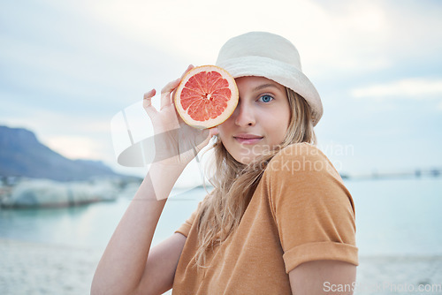 Image of Grapefruit, wellness and woman on tropical beach for nature holiday, vacation or outdoor vitamin c health. Vegan, youth lifestyle for skin care, detox or healthy eating with sky mockup and sea water