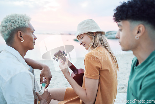 Image of Young friends play music on beach, people on summer holiday and travel outdoor with guitar ukulele in Hawaii. Diversity students vacation together, relax at sea picnic and road trip celebration