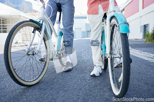 Image of Bicycle, city and couple legs for street exercise or travel in an urban town together for an outdoor adventure. Cycle wheels for tour of people or cycling tourists on a bike in a town in South Africa