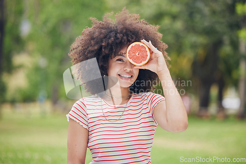 Image of Nature, smile and happy black woman with grapefruit for beauty or healthy body on outdoor day in garden park. Wellness, freedom and relax nutritionist girl with fruit, food or organic health product