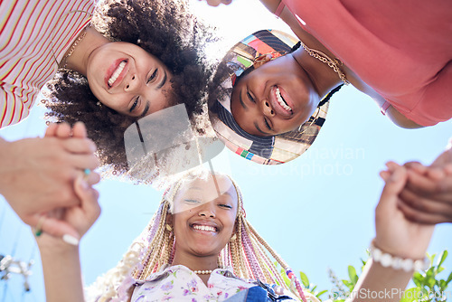 Image of Girl, friends and circle below holding hands together for solidarity, trust and happiness. Black woman, group and huddle with smile, unity and face look on face together for fun, vacation or holiday