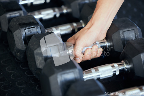 Image of Closeup, hand and gym for exercise with weightlifting, dumbbell and muscle development. Training, sports and workout at fitness center for health, wellness and physical strength in Los Angeles