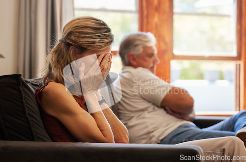 Image of Crying, divorce and fight with a senior woman sad in her home after an argument with her husband. Depression, stress and couple with a wife angry after fighting with her elderly man sitting on a sofa