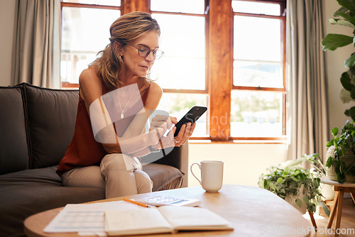 Image of Email, accounting and senior woman planning retirement with help from mobile app and phone on sofa. Elderly accountant reading finance report on the internet with documents and coffee on the couch