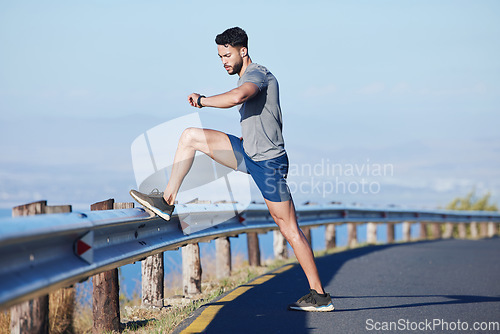 Image of Runner, road and man on time by smartwatch to start running, exercise and cardio workout to burn fat outdoors. Healthy, wellness and athlete monitoring training performance on his fitness journey
