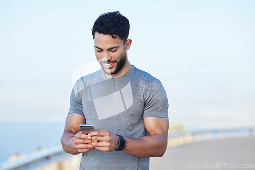 Image of Phone, fitness and app with a sports man tracking his progress online with 5g mobile technology. Exercise, training and workout with a male athlete posting his personal performance to social media