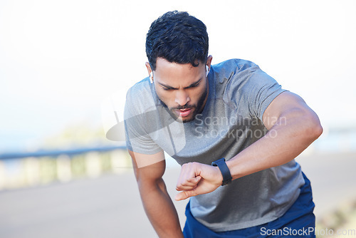 Image of Tired runner, fitness training and man health check on smart watch. Sports athlete training, healthy lifestyle exercise motivation and tracking heartbeat, pulse and measuring speed outdoors