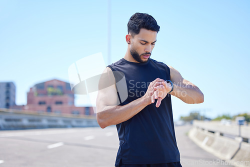 Image of Man check running stats, health and wellness performance or workout endurance on watch tech. Young athlete cardio training, healthy exercise and sport lifestyle or wellness motivation