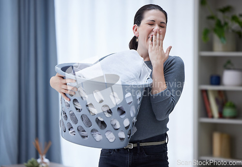 Image of Tired, yawning and woman with laundry basket in home feeling stress, burnout and fatigue from spring cleaning, washing clothes and chores. Exhausted sleepy female covering mouth from bored housework