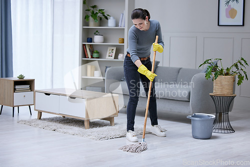 Image of Mopping, floor and woman cleaning the living room of her house. Cleaner or professional worker with apartment service working in housekeeping, care for home and safety from virus with disinfection