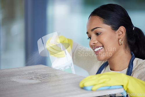 Image of Clean, woman cleaning office with soap detergent product and cloth to disinfect space from dust and germs. Happy, cleaner service, housekeeper, safety gloves and hygiene sanitation of workspace.