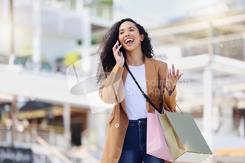 Image of Happy woman, shopping and phone call in the mall in communication about lifestyle in the outdoors. Female shopper having conversation with smile and laugh on mobile smartphone in the city market