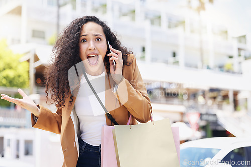 Image of Phone, wow and shopping with a black woman customer looking surprised while in an outdoor city mall. Retail, sale and deal with a young female on a mobile call talking about a store discount