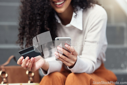 Image of Online shopping, credit card and woman on a smartphone in the city with phone and bank card in hand. Girl on internet doing shopping, ecommerce and retail purchase. Businesswoman doing online banking
