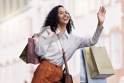 Image of Shopping, travel and woman try to stop taxi for transport in urban city after shopping spree of fashion, sales or discount clothes. Retail, bag and young black customer with hand gesture for cab ride