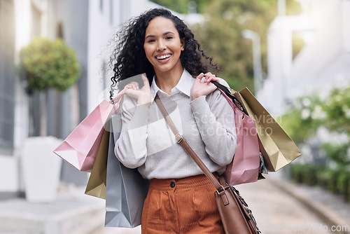 Image of Shopping, retail and city with a black woman customer on the search for a sale, bargain or deal. Money, consumer and shopper with young female at an outdoor store or mall for buying and spending