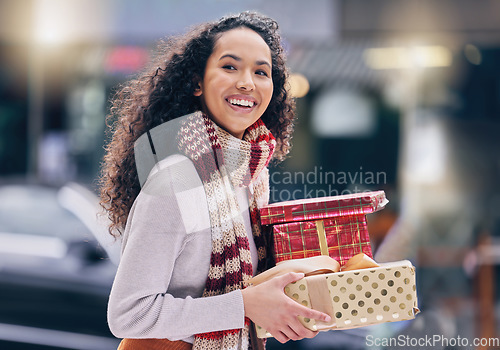 Image of Christmas gift shopping, customer and city girl buy sales, discount or retail product for festive season. Happiness, presents and smile from happy black woman on shopping spree travel in urban town