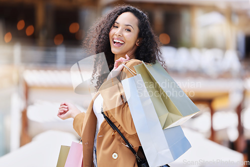 Image of Shopping, happy and portrait of customer with bag after shopping spree buying retail fashion product on store discount. Sales, smile and young black woman at luxury shopping mall to purchase clothes