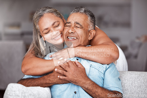 Image of Happy senior couple, hug and relax in love for relationship bonding together in tender happiness at home. Joyful elderly man and woman smile in hope embracing romance for retirement house on sofa